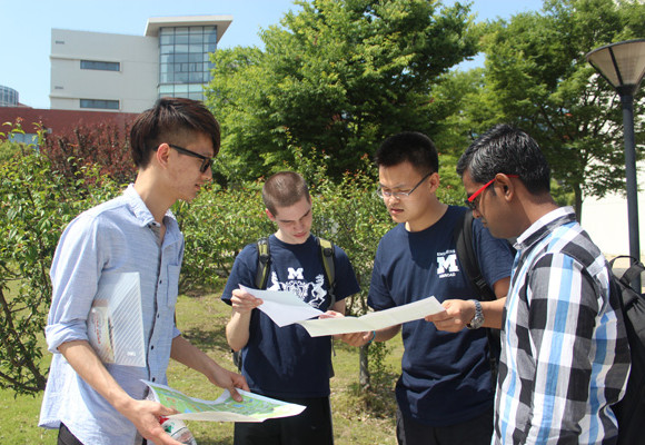 Students studying the maps of the scavenger hunt